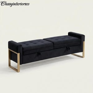 May include: A black upholstered storage bench with a tufted seat and gold-colored metal frame. The bench has two sections with pull tabs for storage. The text "Classyinteriorsco" is in the upper left corner.