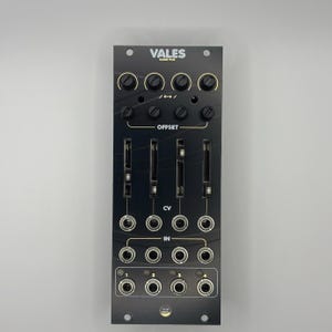 May include: Black electronic music synthesizer module with the text "VALES QUAD VCA". The module features knobs, sliders, and input/output jacks. It is designed for electronic music production and performance.