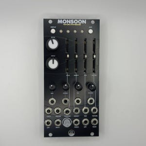 May include: Black electronic synthesizer module with the text "MONSOON TEXTURE SYNTHESIZER". It features knobs, sliders, and input/output jacks. The module has a sleek, modern design with white and silver accents.
