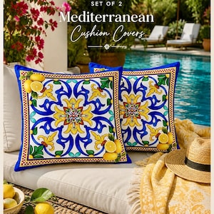 May include: A set of two square cushion covers featuring a vibrant Mediterranean-inspired pattern with blue, yellow, and green floral motifs and lemon illustrations. The text reads SET OF 2 Mediterranean Cushion Covers.