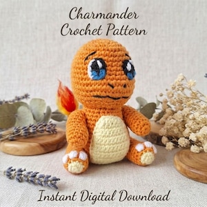 May include: A crocheted orange creature with a cream-colored belly, blue eyes, and a small flame on its tail. The text Charmander Crochet Pattern and Instant Digital Download are visible. The figure is seated and features white claw details.