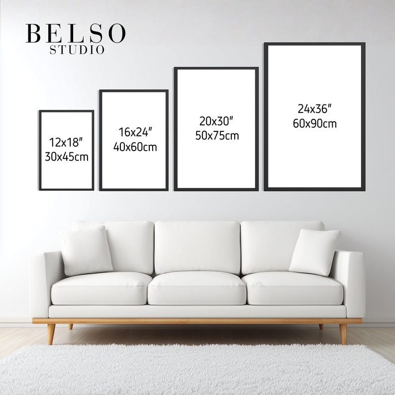 May include: Four framed art prints of varying sizes, displayed above a white sofa and a white rug. The frames are black, and the prints are blank. The sizes are 12x18 inches, 16x24 inches, 20x30 inches, and 24x36 inches.