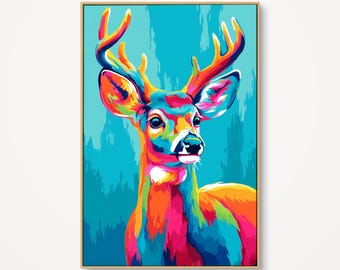 May include: A framed, vibrant pop art painting of a deer. The deer is depicted with a colorful palette of orange, pink, yellow, and blue hues. The background is a solid teal color. The artwork is encased in a gold frame.