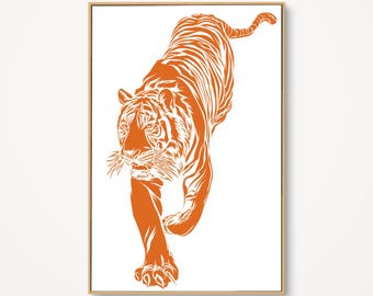 May include: Orange and white tiger art print. The artwork depicts a tiger walking towards the viewer. The tiger is orange with white stripes and is set against a white background. The artwork is framed in a light brown frame.