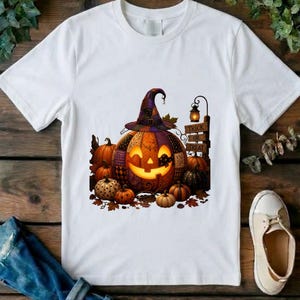 May include: A white t-shirt featuring a graphic of a large, glowing jack-o'-lantern wearing a purple and black patterned witch hat. The design includes several smaller pumpkins, autumn leaves, and a signpost with the text Trick or Treat.