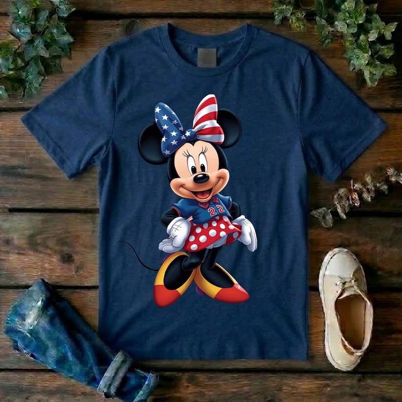 May include: A navy blue short-sleeve t-shirt featuring a graphic of a cartoon mouse character wearing a red, white, and blue star-patterned bow, a blue jersey with the number 22, a red and white polka dot skirt, and yellow shoes.