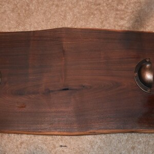 Solid live edge slab of walnut shows the besuty that it has. The metal handles blend so well with the board and colors.
