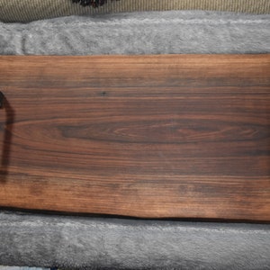 Solid live edge slab of walnut shows the besuty that it has.