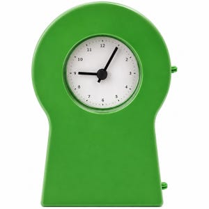 May include: A bright green analog clock with a keyhole-shaped frame. The clock face is white with black numerals from 1 to 12 and black hour and minute hands. The design features a smooth, solid-colored plastic casing with a rounded top section.