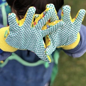May include: A pair of yellow gardening gloves with a green and white polka dot pattern and colorful cartoon images. The gloves have a textured grip.