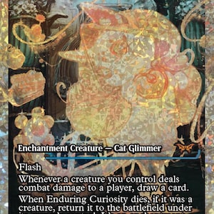 May include: A holographic trading card titled Enduring Curiosity featuring a stylized, glowing orange cat figure. The card text includes Enchantment Creature - Cat Glimmer, Flash, and game rules. The background displays a dark, intricate scene with shimmering, prismatic foil patterns across the entire surface.
