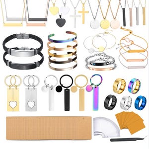 May include: A collection of jewelry including necklaces with bar and cross pendants, braided leather and metal bracelets, cuff bangles, chain bracelets, keychains with heart and bar charms, and rings in various metallic finishes, plus display cards.