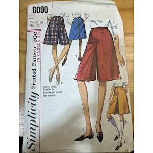 May include: A vintage Simplicity sewing pattern, number 6090, featuring illustrations of culottes in different colours and patterns. The pattern includes measurements for a Miss with a 26-inch waist and 36-inch hips. Marked "50c in Canada".