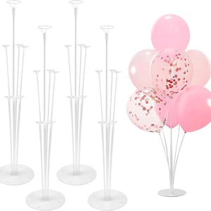 May include: A set of clear plastic balloon stands with multiple tiers for holding balloons. The image also shows a cluster of pink balloons, some with confetti, attached to a stand. Perfect for parties and celebrations.