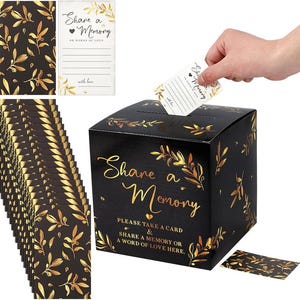 May include: A black square box with gold foil leaf patterns and the text Share a Memory, Please Take a Card & Share a Memory or a Word of Love Here. Includes a stack of matching black and gold cards with the text Share a Memory or Words of Love.