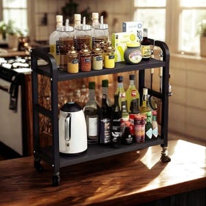 May include: A black metal kitchen cart with two shelves, filled with various bottles, jars, and a white electric kettle. The top shelf holds glass bottles with oil and spices, while the bottom shelf displays wine and other beverages.
