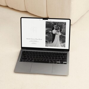 Classic monochrome Canva wedding website template desktop mockup — elegant minimalist wedding website with custom monogram, and black and white photography