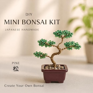 May include: A DIY Mini Bonsai Kit with a handmade Japanese design. The bonsai features a wire trunk and green beaded foliage, planted in a small, dark red square pot filled with pebbles. The text "PINE" and Japanese characters are visible.