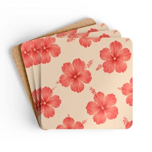 May include: A stack of four square coasters with rounded corners, featuring a repeating pattern of coral-red hibiscus flowers on a light beige background. Each coaster has a visible brown cork backing and a smooth, printed top surface.