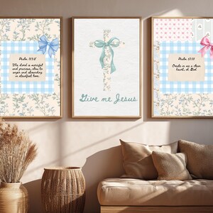 May include: Three framed art prints with floral and gingham patterns. Each print features a Bible verse and a decorative bow. The central print displays a cross with a ribbon and the words "Give me Jesus". The color palette includes beige, blue, and pink.