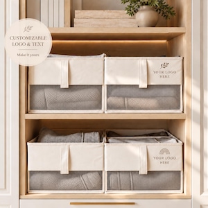 May include: Four rectangular off-white fabric storage bins with mesh front panels, arranged on two wooden shelves. Each bin features a vertical fabric pull tab. Two bins display the text "YOUR LOGO HERE" with a leaf or rainbow icon.