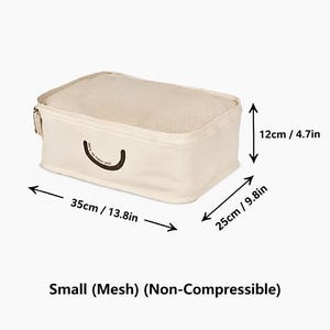 May include: A small, non-compressible beige packing cube with a mesh top and a zipper closure. The dimensions are 13.8 inches in length, 9.8 inches in width, and 4.7 inches in height. A small dark brown curved graphic is printed on the side.