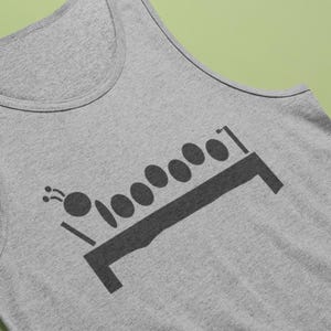 May include: A gray tank top with a black graphic of a stylized caterpillar on a bench. The caterpillar has a round head with antennae and a series of oval body segments. The bench has a rectangular base.