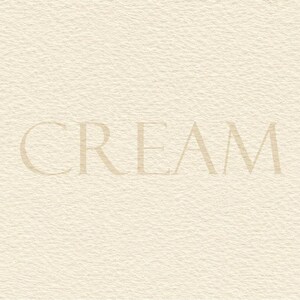 May include: A textured, off-white paper background featuring the word CREAM printed in a centred, serif font. The surface has a visible, slightly rough, and fibrous grain pattern consistent with high-quality cardstock or heavy paper material.