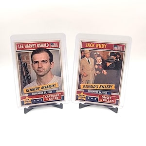 May include: A white ceramic mug with a black handle and the text "But First, Coffee" in a bold, black font. The mug is sitting on a wooden surface. The mug is approximately 4 inches tall.