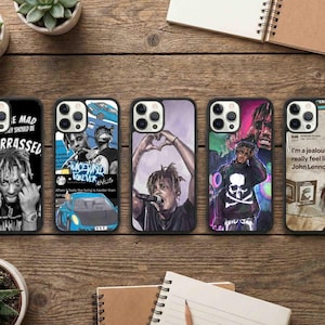 May include: Five black phone cases with different designs. One case has a black and white image of a person with the text "E MAD Y SHOULD BE MBARRASSED". Other cases feature images of a person with text and graphics.
