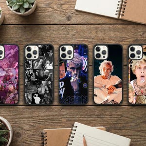 May include: Five black phone cases with different designs. One case has a collage of images with the text "I'M GOOD THAT'S IT" and "SUNSHINE GUNS". Another case has a black and white collage. The other three cases feature images of a person.