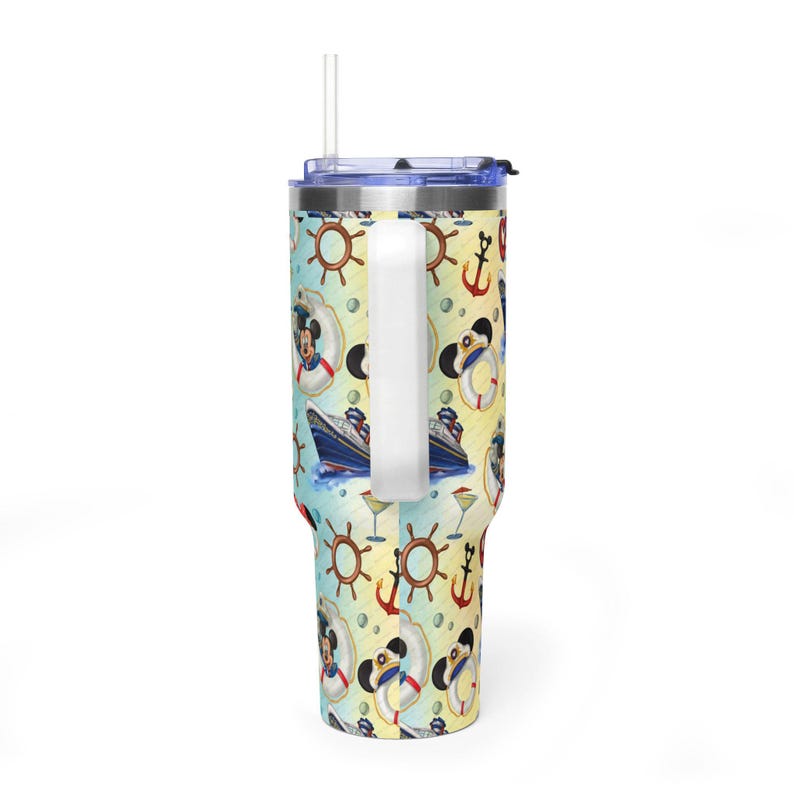 May include: A stainless steel tumbler with a handle, a clear lid, and a straw. The exterior features a repeating pattern of cruise ships, anchors, ship wheels, cocktails, and a cartoon mouse character wearing a sailor hat and life preserver.