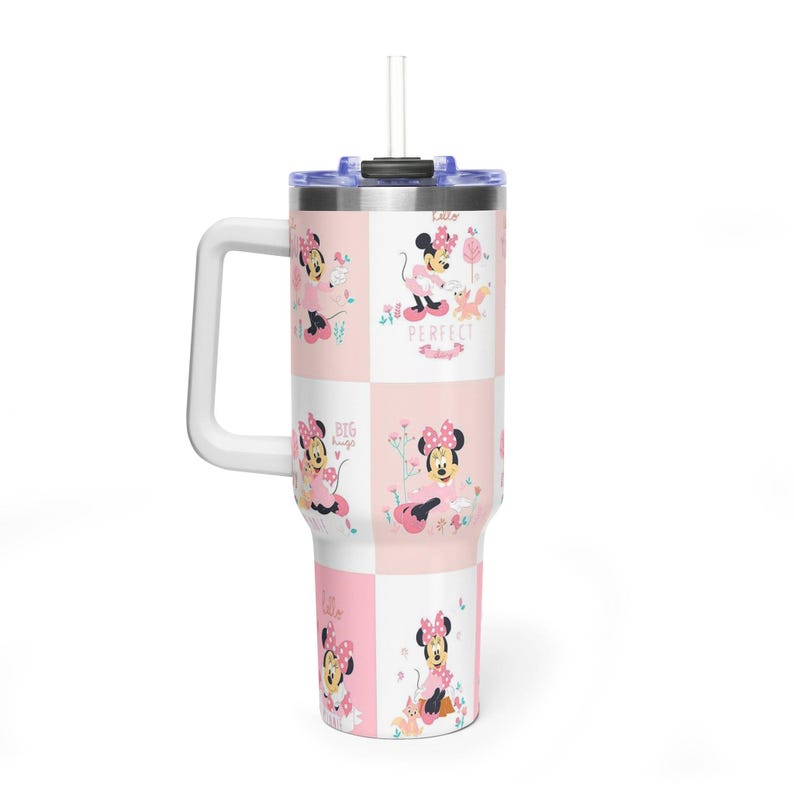 May include: A white and pink travel mug with a handle, featuring a repeating pattern of Minnie Mouse. The mug has a blue lid and a white straw. The words "Perfect" and "Big Hugs" are visible.