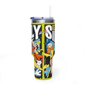 May include: A stainless steel tumbler with a vibrant design featuring Mickey Mouse, Donald Duck, and Goofy. The tumbler has a black, yellow, and blue design with the words "ONLY SIDE" in large white letters. It includes a clear lid and a white straw.