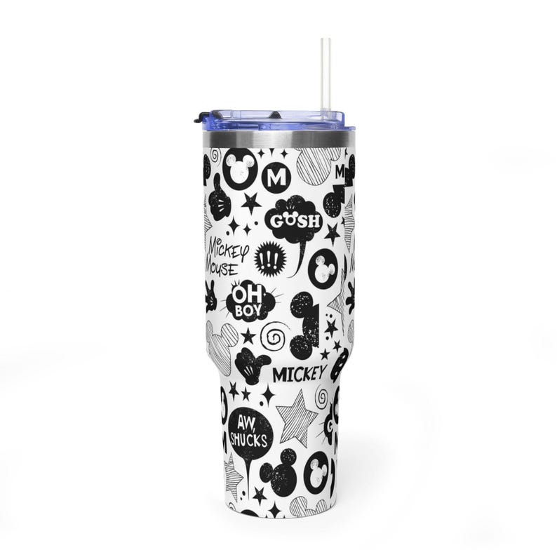 May include: A white tumbler with a black and white cartoon design featuring Mickey Mouse. The tumbler has a blue lid and a clear straw. The design includes speech bubbles with phrases like "Gush" and "Aw Shucks."
