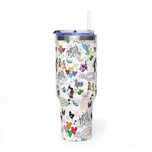 Puede incluir: Un vaso blanco con tapa y pajita azules, cubierto con un patr&oacute;n caprichoso con tem&aacute;tica de Disney. El dise&ntilde;o incluye personajes de dibujos animados, castillos, globos y las palabras "Walt Disney World" en un patr&oacute;n repetido. El vaso est&aacute; dise&ntilde;ado para contener aproximadamente 887 ml.