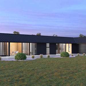 May include: A modern, single-story house with a dark roof and black exterior walls. Large glass windows and doors offer views of the interior. The house is surrounded by a green lawn and small bushes.