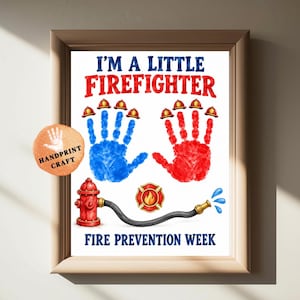 May include: A framed print featuring the text I'M A LITTLE FIERFIGHTER and FIRE PREVENTION WEEK. It displays two handprints, one blue and one red, each topped with small firefighter helmets. A red fire hydrant with a hose and a flame emblem.