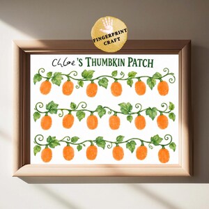 May include: A framed print featuring the text Chloe's Thumbkin Patch in green letters. The design includes three horizontal rows of watercolor-style orange pumpkins attached to green vines with leaves, intended for adding thumbprint art.