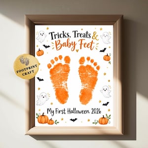 May include: A framed print featuring two orange baby footprints in the center, surrounded by illustrations of ghosts, bats, pumpkins, and stars. The text reads "Tricks, Treats & Baby Feet" and "My First Halloween 2026" in black and orange.