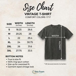 May include: A size chart for a vintage t-shirt, with measurements in inches. The chart includes sizes S to 3XL, with width and length dimensions. The shirt is a dark gray color, with the text "Sea Foam" at the bottom.
