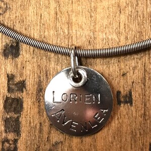 Sterling silver charm with names and words.