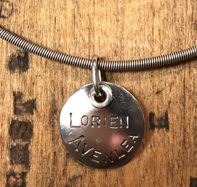 Sterling silver charm with names and words.