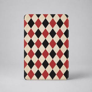 May include: A rectangular tablet case featuring a repeating harlequin pattern of black, red, and cream-coloured diamonds. The design covers the entire front surface of the case, which has rounded corners and a flat, smooth, matte-textured finish.