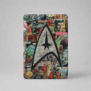 May include: A rectangular metal tin featuring a collage of vintage Star Trek comic book panels in various colors. A large, bold black Starfleet delta insignia is centered over the comic imagery, which depicts characters in red uniforms and starships.
