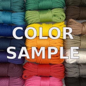 May include: Color sample of different colored ropes. The ropes are arranged in rows and columns, with the colors ranging from green to red to pink. The text "COLOR SAMPLE" is printed in white letters on a black background.