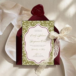 May include: Wedding invitation with a floral design and burgundy accents. The invitation card features the names "Emily Johnson" and "Benjamin Clark" and is tied with a cream lace ribbon. A burgundy envelope is sealed with a wax stamp.