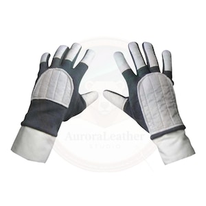 May include: A pair of gloves with a dark grey body, white fingertips, and white padded knuckles. The gloves have white cuffs and are displayed against a white background. The gloves are likely for protection or sports.