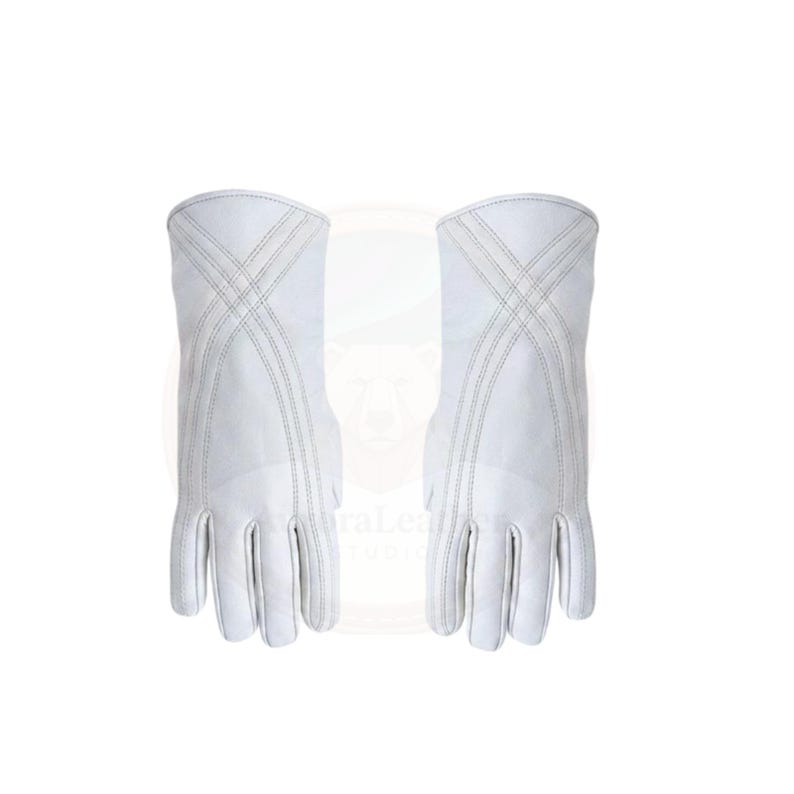 May include: A pair of white leather gloves with a long cuff. The gloves have a crisscross stitch design on the back of the hand and cuff. The gloves are made of a smooth, soft leather.