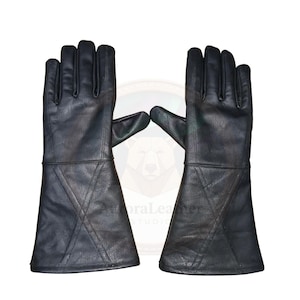 May include: A pair of black leather gloves with long gauntlets. The gloves have a classic design with stitched details on the gauntlets. The leather appears to be smooth and the gloves are designed for protection.
